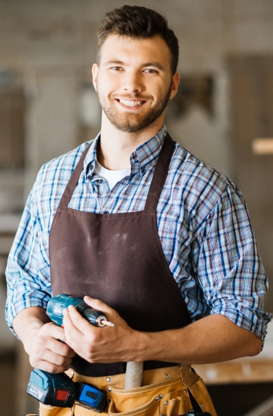 smiling-craftsman-with-electric-drill